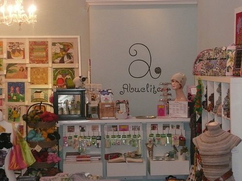 Needlepoint canvases, notions and a painted Abuelita's sign on the shop wall